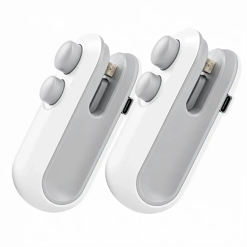 Duas seladoras e cortadoras de embalagens Decoricasa brancas e cinzas, recarregáveis via USB, design compacto e ergonômico.