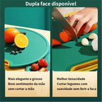 Tábua de corte dupla face Decoricasa verde com textura antiderrapante sendo usada para cortar vegetais e frutas.